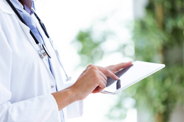 istock Female doctor using her digital tablet in the consultation. 1010842280