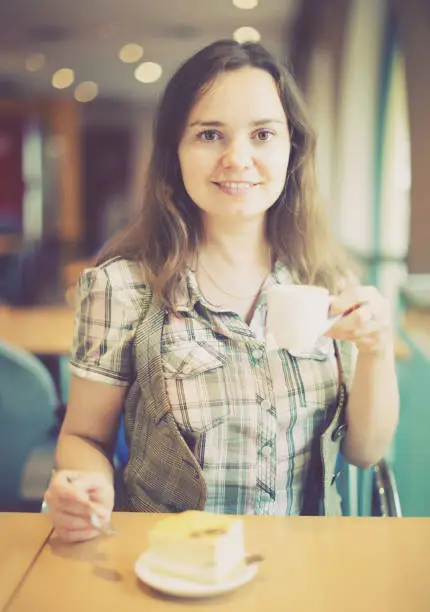 Photo of Cheerful girl drinking morning coffee