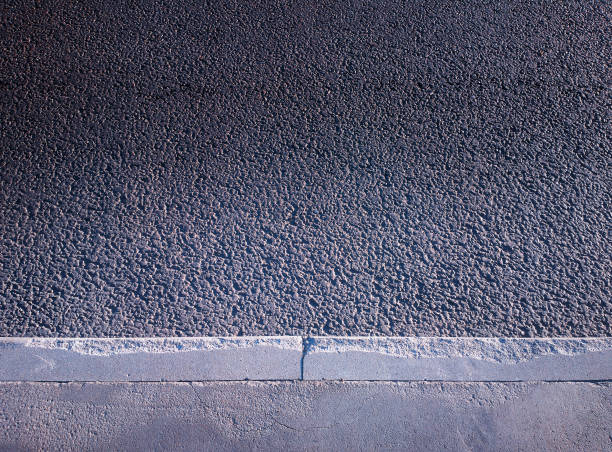 istock Edge of sidewalk pavement texture background 1010846520