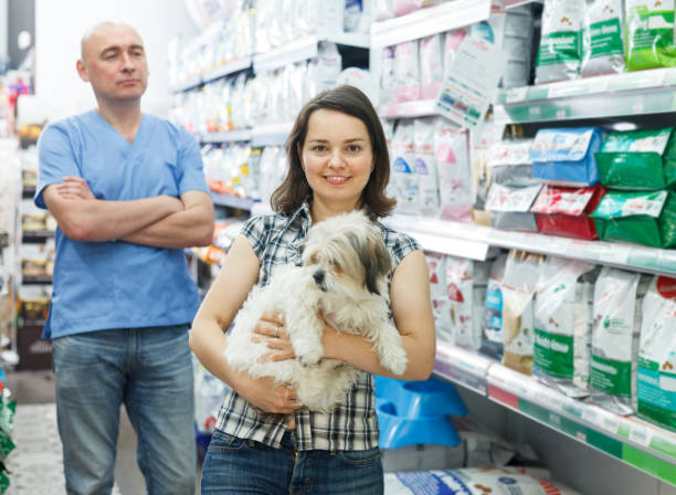 istock woman with dog  in pet store 1010847200