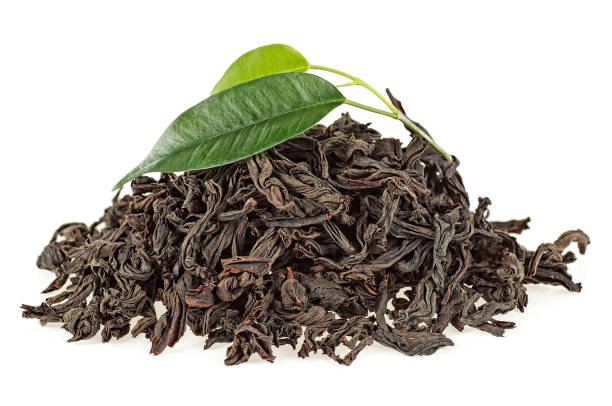 istock Dried black tea with green leaves isolated on white background 1010847610