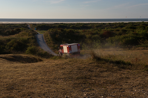Firetruck deploying in the dunes of the dutch Island Schiermonnikoog to fight multiple forest fires in July 2018 were many fires were caused due to the hot and dry summer.