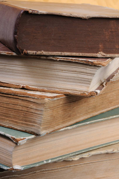 istock Old vintage books in a pile on a yellow background. 1010851200