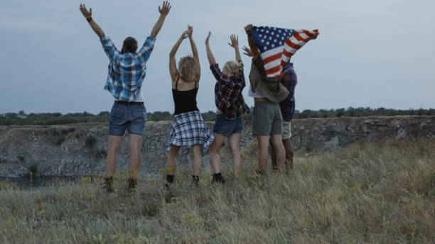 istock Traveling friends with flag on cliff 1010851242