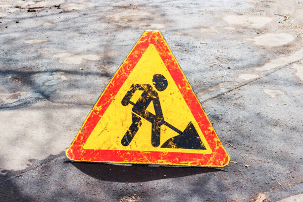 istock Works ahead warning sign on a road 1010852290