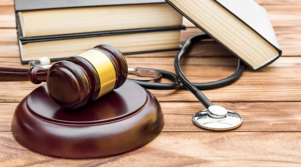 Gavel with stethoscope and books on the table. stock photo
