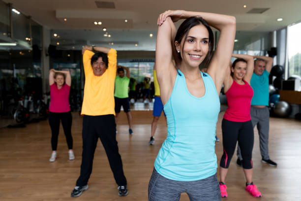 istock Female instructor at the gym stretching in a class 1010878444