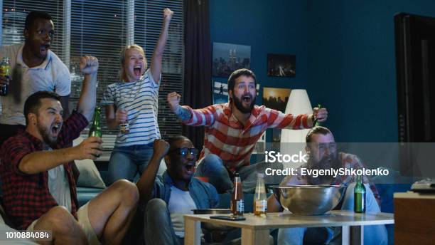Excited Fans Cheering For Sport Team Watching Game Stock Photo - Download Image Now - Watching, Sport, Match - Sport