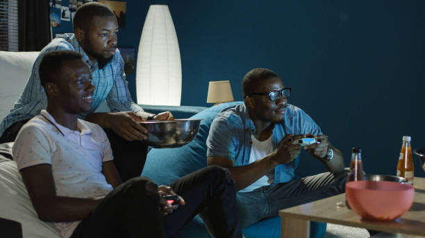 istock Black man having fun with videogame at home 1010884534
