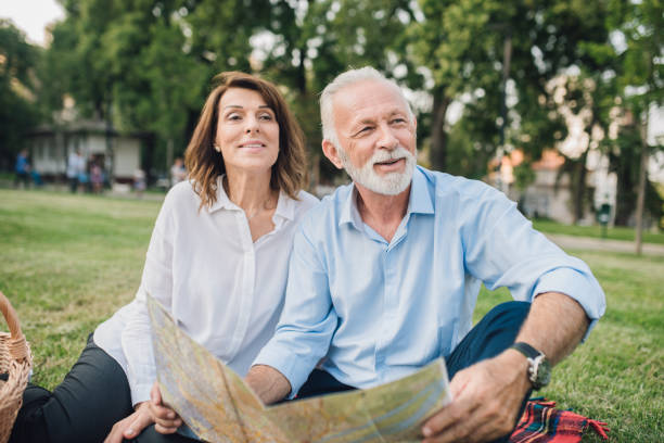 istock Smiling senior couple with touristic map 1010902432