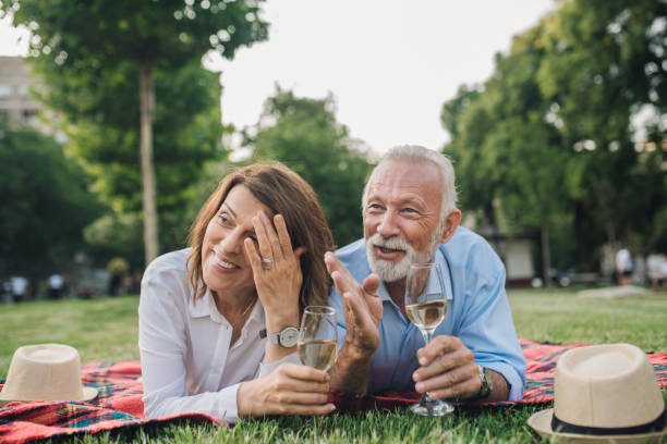 istock Happy older couple drinking white wine on a picnic 1010906198