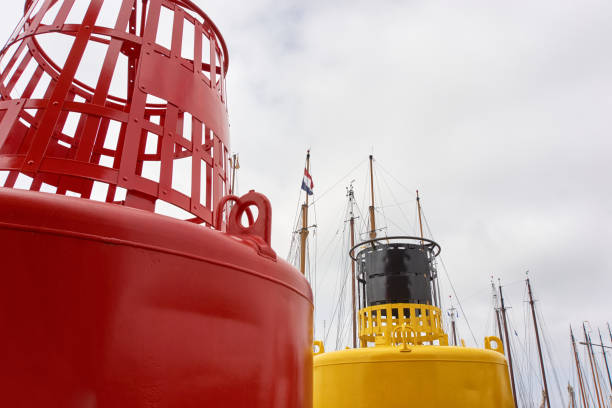 istock Red and yellow buoy against a grey cloudy sky 1010906782
