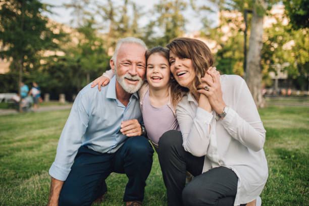 istock Young girl hugging her grandparents 1010925236