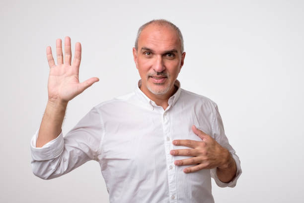 istock Friendly-looking attractive european man waiving hand in hello gesture while smiling cheerfully. 1010933766