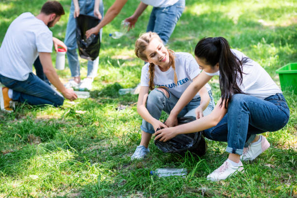 istock young volunteers cleaning lawn in park 1010944064