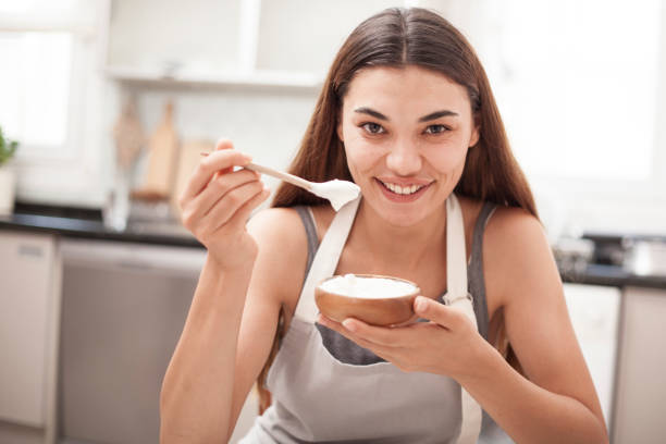 istock woman eating yoghurt at the kitchen 1010948554