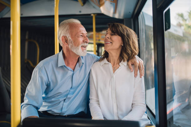 istock Happy older couple riding on the bus 1010951462