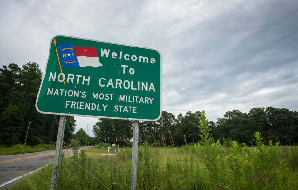 "Welcome to North Carolina" Sign A sign on a two-lane country road welcomes residents and visitors to North Carolina. mendocino county photos stock pictures, royalty-free photos & images