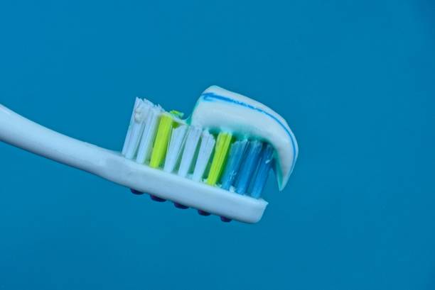 istock part of a toothbrush with toothpaste on a blue background 1010972538
