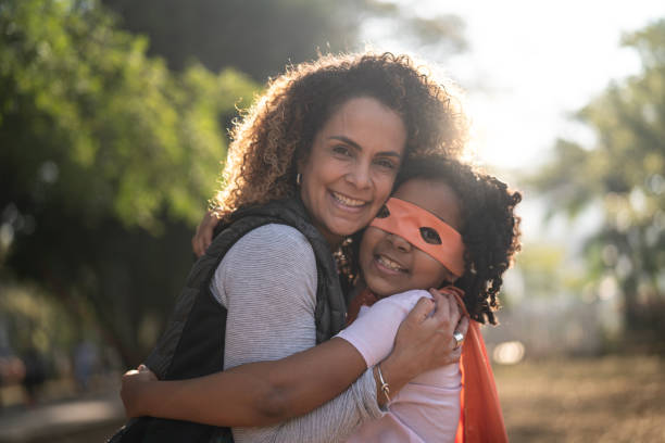 istock Super Hero Daughter Embracing Her Mother 1010972630