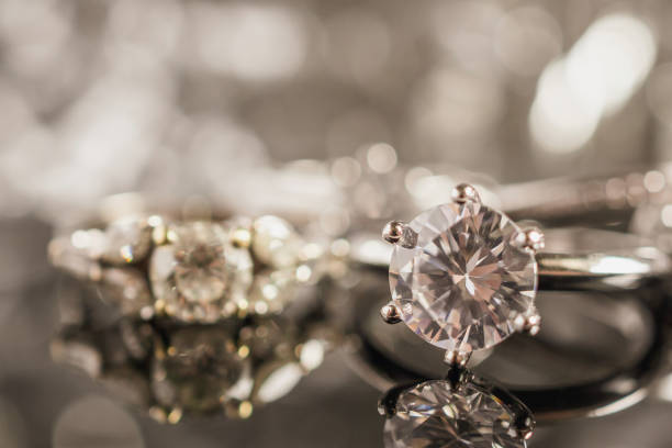 istock Luxury Jewelry diamond rings with reflection on black background 1010980516