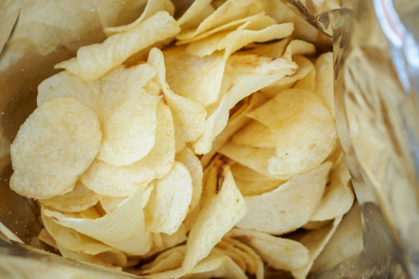 istock Potato chips in open snack bag close up 1010980822