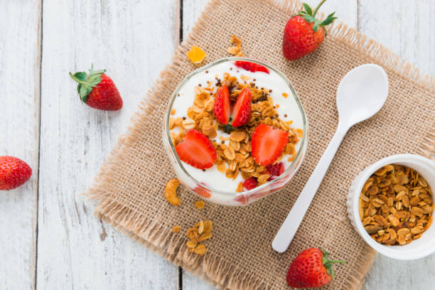 Strawberry , granola and yogurt healthy breakfast parfait Strawberry , granola and yogurt healthy breakfast parfait on wooden background topview yogurt parfait stock pictures, royalty-free photos & images