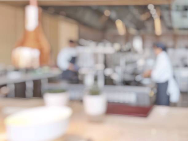 istock Open kitchen blur background in luxury hotel restaurant facility showing chef cooking over blurry food counter for buffet catering service 1010984000