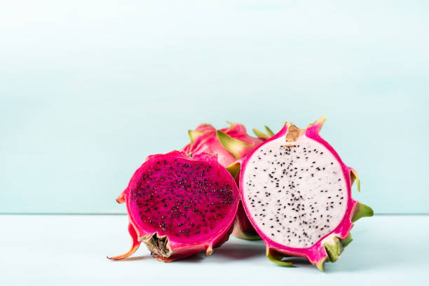 istock Half red and white dragon fruit on color background 1010987598
