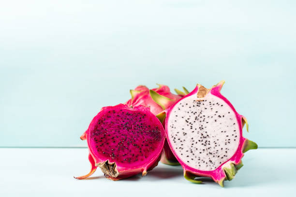 Half red and white dragon fruit on color background Half red and white dragon fruit on color background, tropical fruit pitaya photos stock pictures, royalty-free photos & images