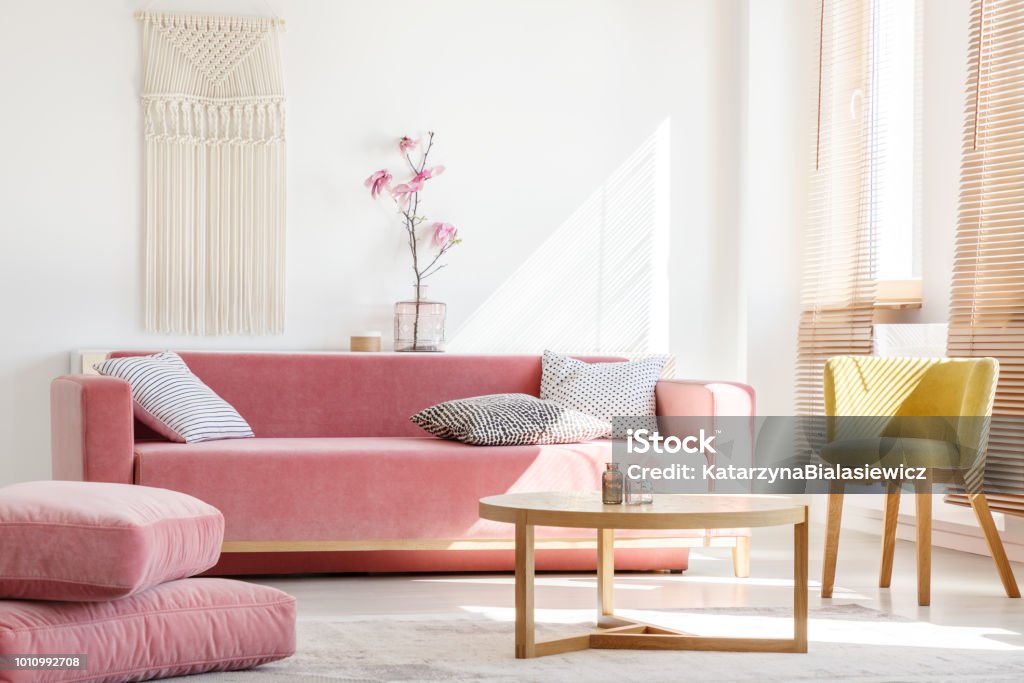 https://media.istockphoto.com/id/1010992708/photo/real-photo-of-a-pink-couch-with-pillows-standing-next-to-big-pillows-and-yellow-armchair-and.jpg?s=1024x1024&w=is&k=20&c=d6pvJkWKewvEfe9UqVWJdseKDmkBgk45aIpd6w67oJA=