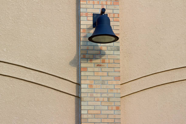 istock Light color brick and stone building exterior wall background with lamp 1011032830