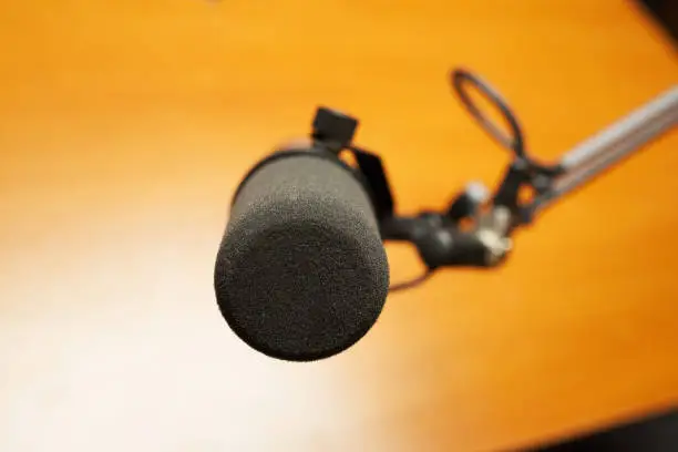 Black microphone on a yellow background