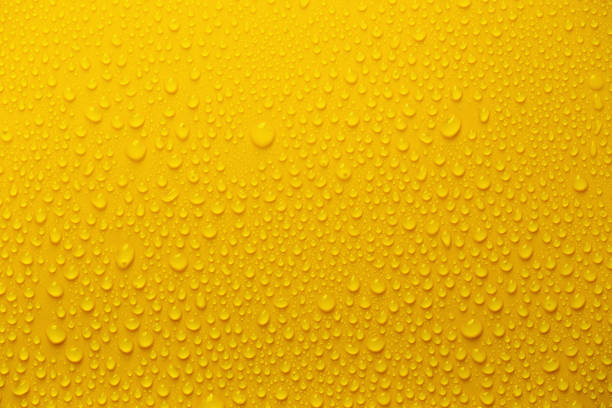 istock Rain or Water drops on yellow background 1011041878