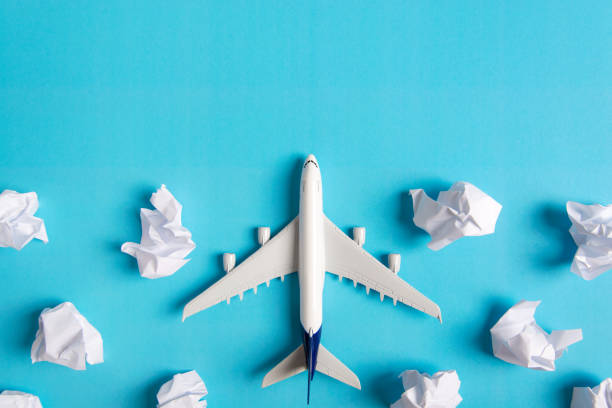 Airplane model flying among paper clouds, Traveling concept Airplane model flying among paper clouds, Traveling concept toy airplane stock pictures, royalty-free photos & images