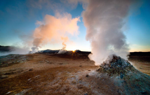 Icelandic sunrise A beautiful dawn in Iceland, a country with many geothermal features including these dramatic fumaroles. Shot with a wide angle lens for dramatic effect and a small aperture to create a sunstar where the sun is just peaking over the horizon. The scenery in Iceland is spectacular and it is becoming a popular tourist destination. hot spring stock pictures, royalty-free photos & images