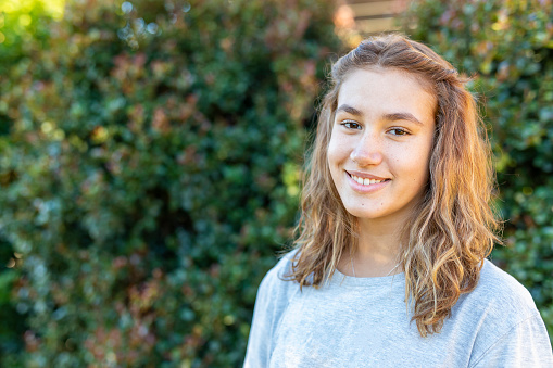 Portrait of a Happy Teenage Maori Girl Smiling in the Backyard