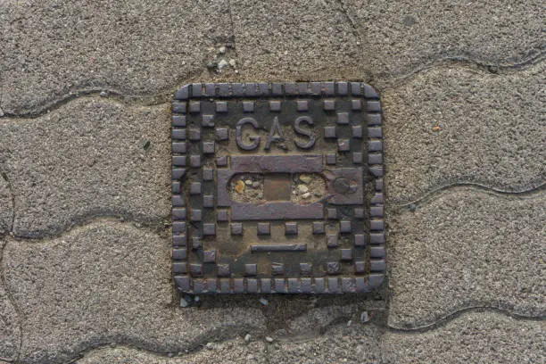 surface box on street made of metal saying "gas"