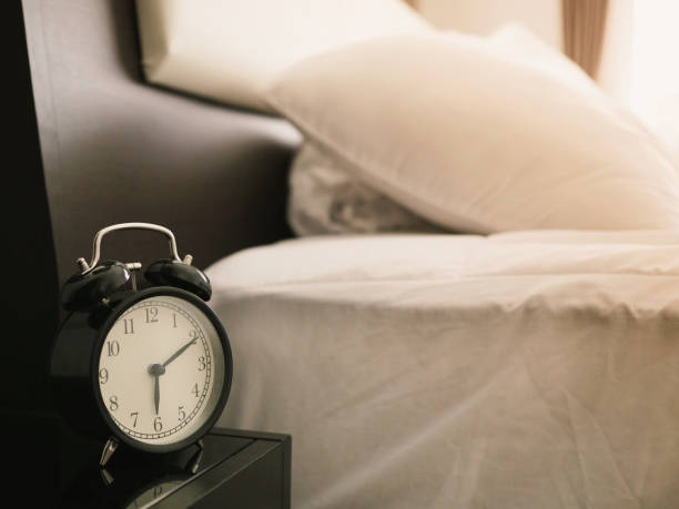 istock Alarm clock on the bed in bed room 1011073030