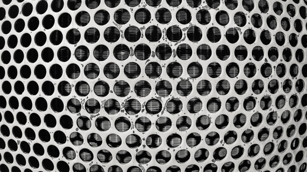 istock perforated steel plate for background, Iron perforated sheet metal.Black And White Abstract Background 1011076706