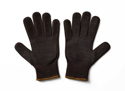 Brown working knitted glove with rubber dots, isolated on white with clipping path.