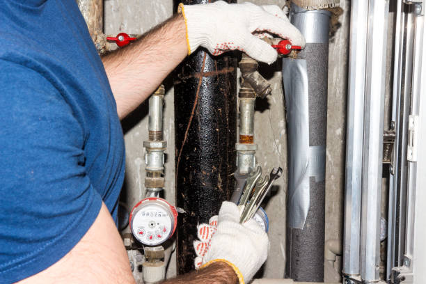 plumber repairs the pipes. A man from the service and maintenance of pipes and sewerage. stock photo