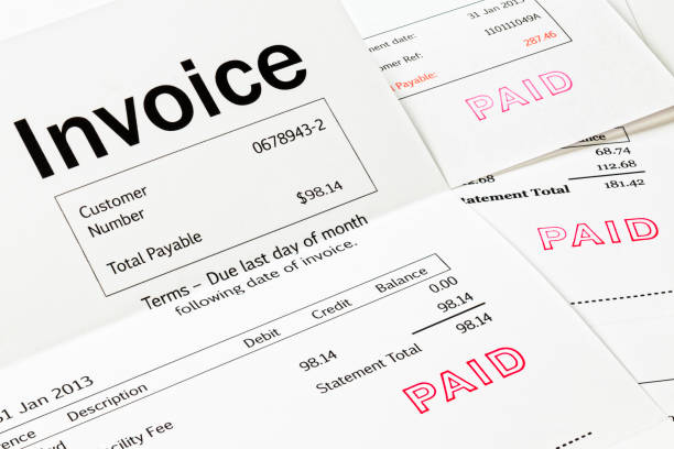 Invoices with Paid Stamp Invoice with Paid Stamp - three invoices with paid stamped on them. All details are imaginary. financial bill stock pictures, royalty-free photos & images