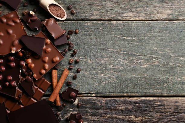istock Chocolate pieces with nuts and coffee beans on wooden table 1011103590