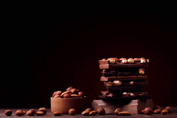 istock Chocolate pieces with nuts on wooden table 1011104636