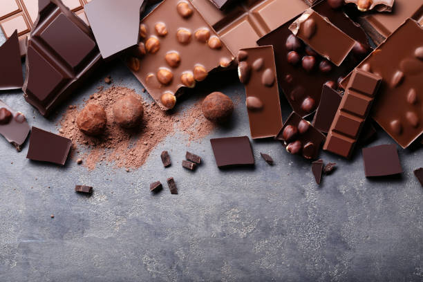istock Chocolate pieces with nuts and candy balls on wooden table 1011108638