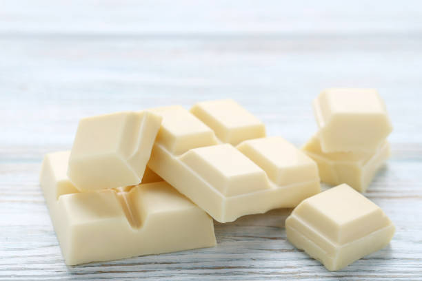 istock White chocolate pieces on wooden table 1011112748