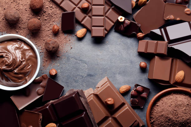 istock Chocolate pieces with nuts and cocoa balls on grey wooden table 1011112788