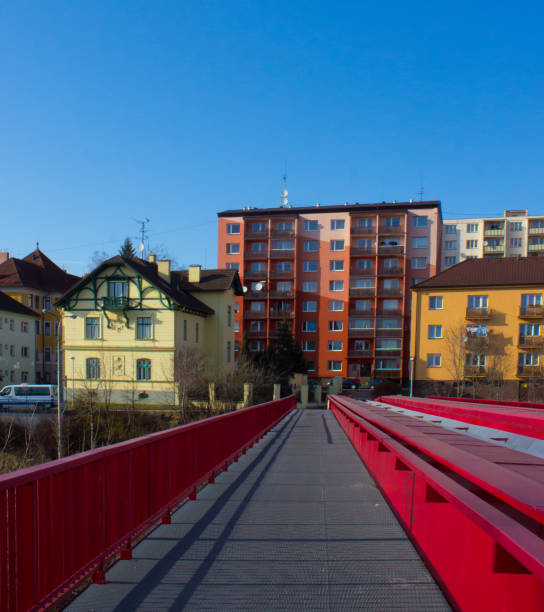 istock Metallic red bridge over railway and block of flats 1011113238