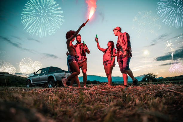 istock Friends enjoying holidays celebrating outdoors with fireworks 1011113254